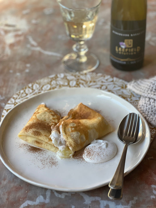 Apple crêpes paired with a glass of Leefield Station Riesling, highlighting its fresh acidity.