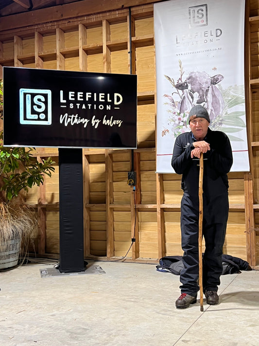 A farmer selling bulls outside Leefield Station vineyard, with rolling vineyards in the background.