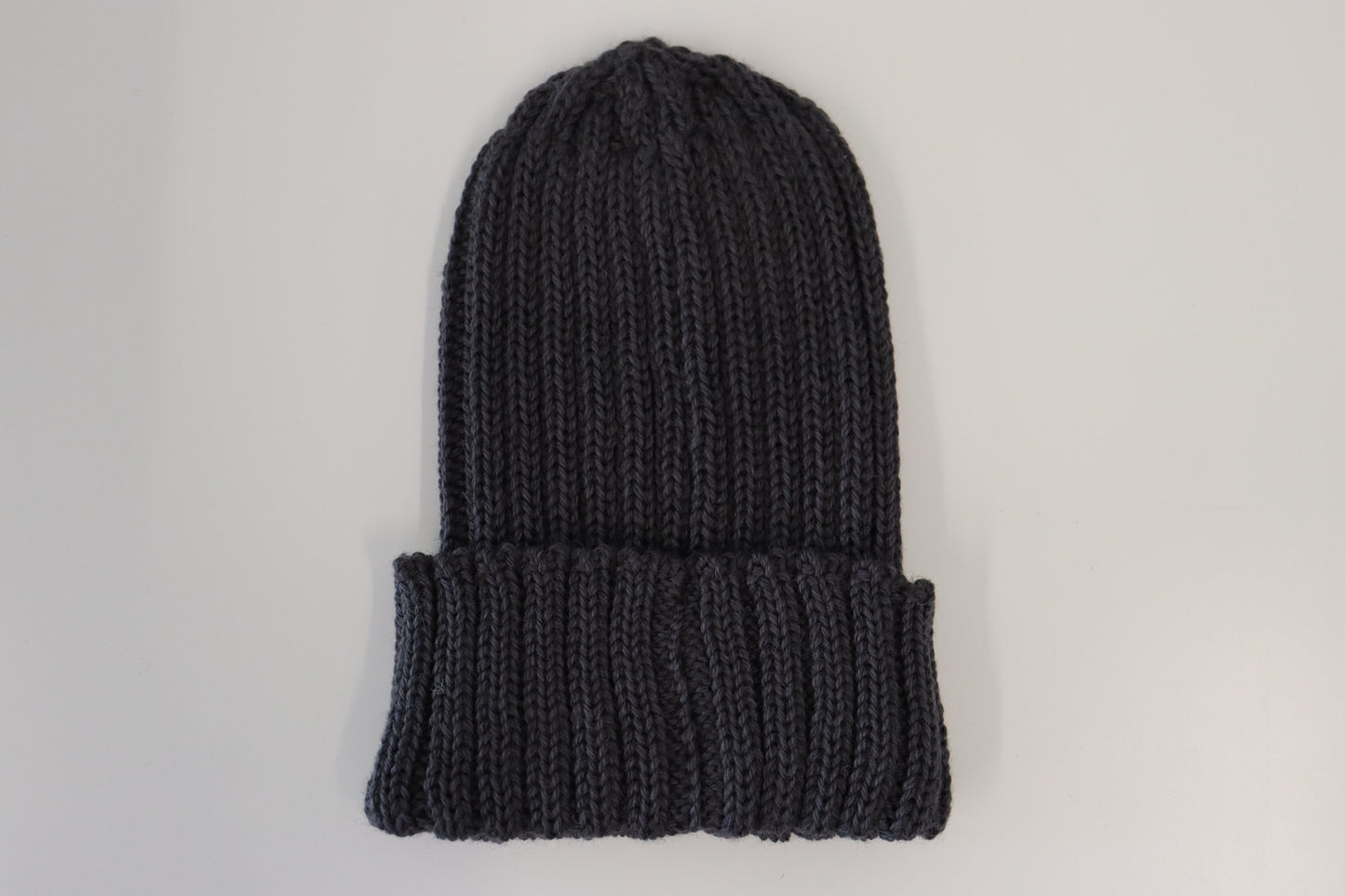 The LEEFIELD STATION BEANIE, a dark gray knitted beanie from Marisco Family Vineyards with a folded cuff, is displayed on a plain white background.