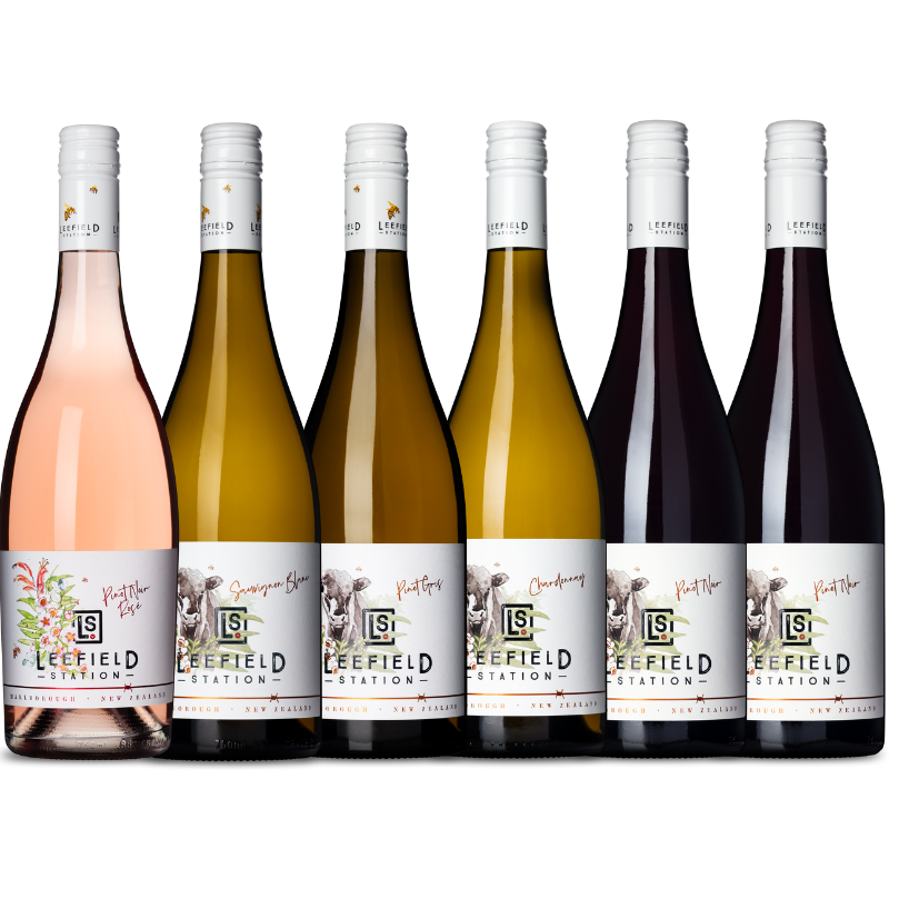 The LEEFIELD STATION MIXED CASE from Marisco Family Vineyards elegantly showcases six wine bottles from Marlborough, featuring rosé, Sauvignon Blanc, Chardonnay, and three Pinot Noir bottles. Each label is adorned with floral or bird illustrations accented in gold foil alongside the brand logo.