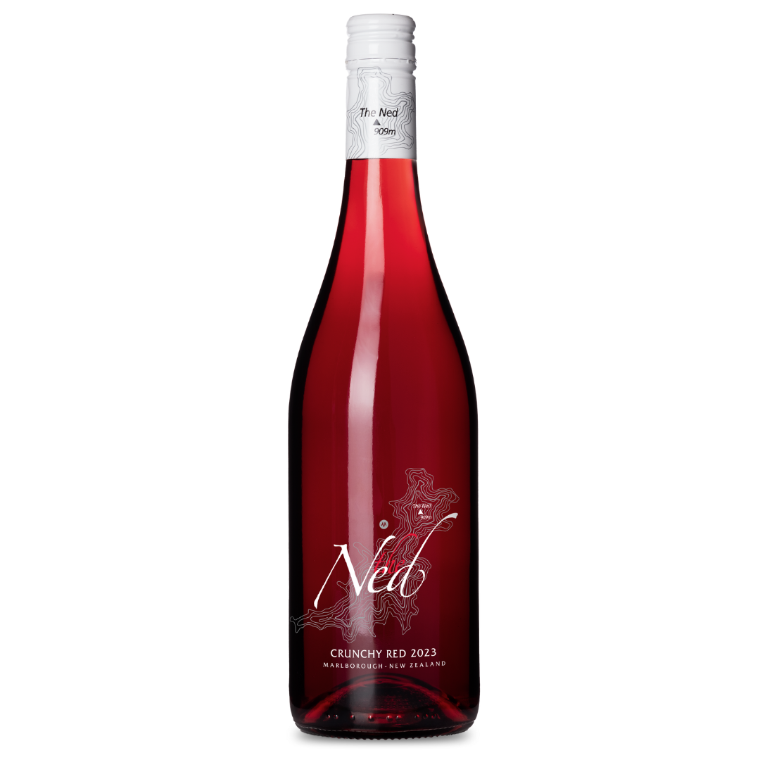 The Ned Crunchy Red 2023 is a captivating Pinot Noir from New Zealands Marlborough. Its vibrant red hue stands out, complemented by a white cap and a clear label featuring The Ned brand and vintage year.